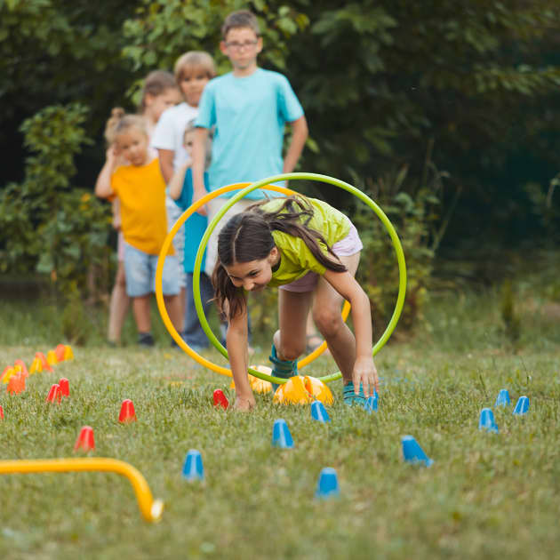 Preschool girl running fast and play catch-up and tag game