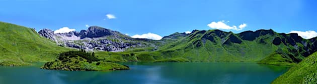 A lake with mountains in the background