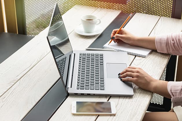 young woman working on laptop typing 